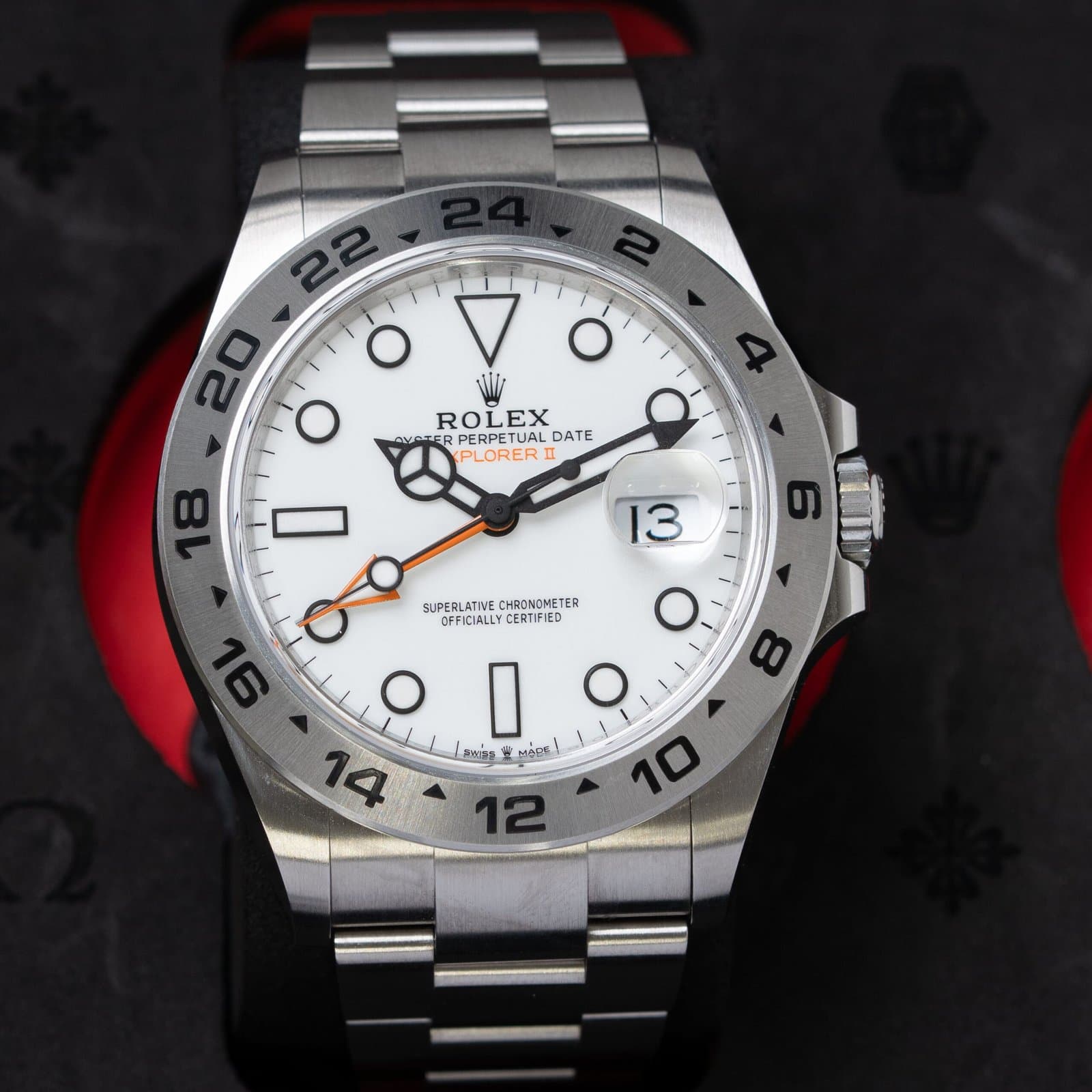 Steel Rolex Explorer II with a white dial and orange GMT hand on an Oyster bracelet