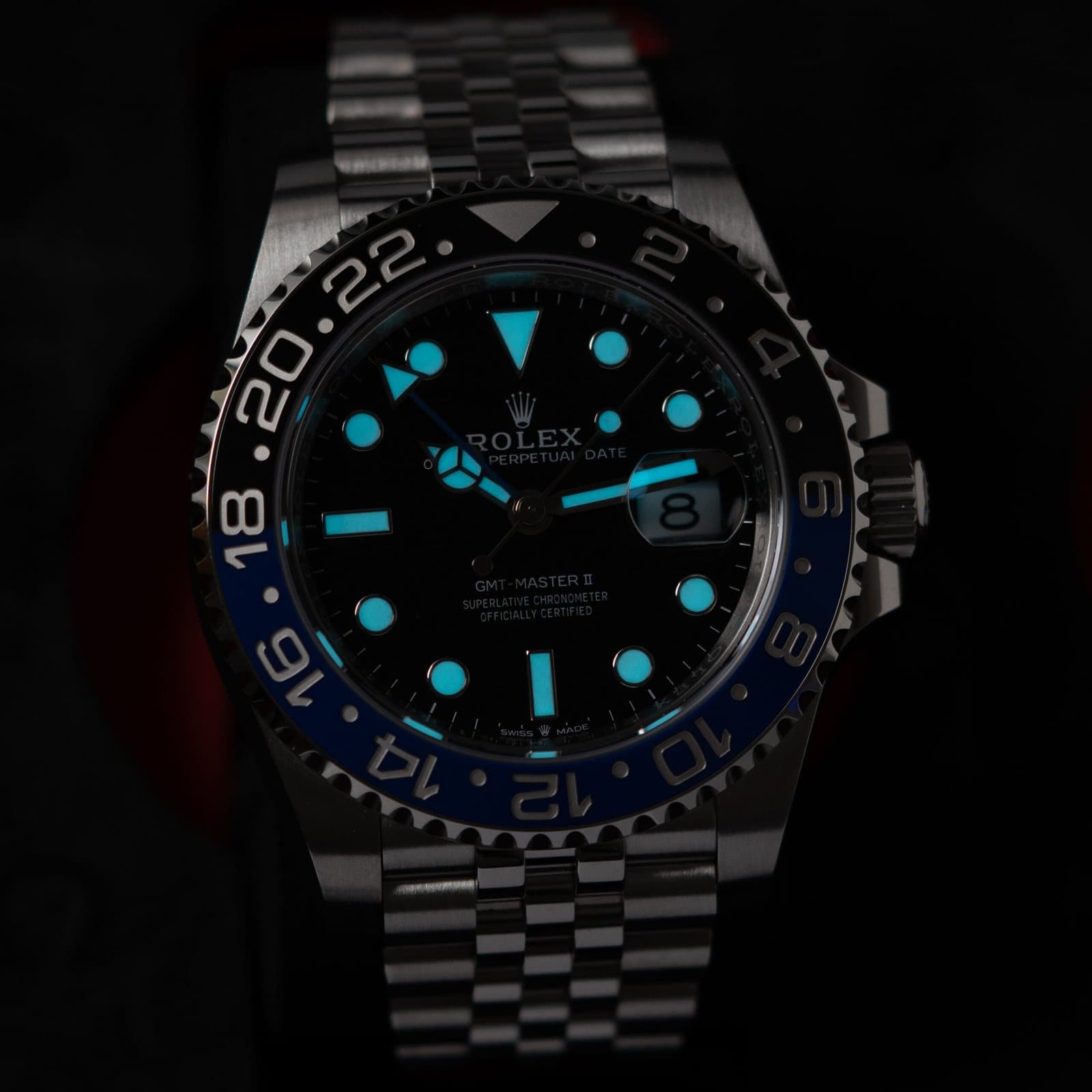 Rolex GMT-Master II with black and blue bezel, its lume glowing in the dark