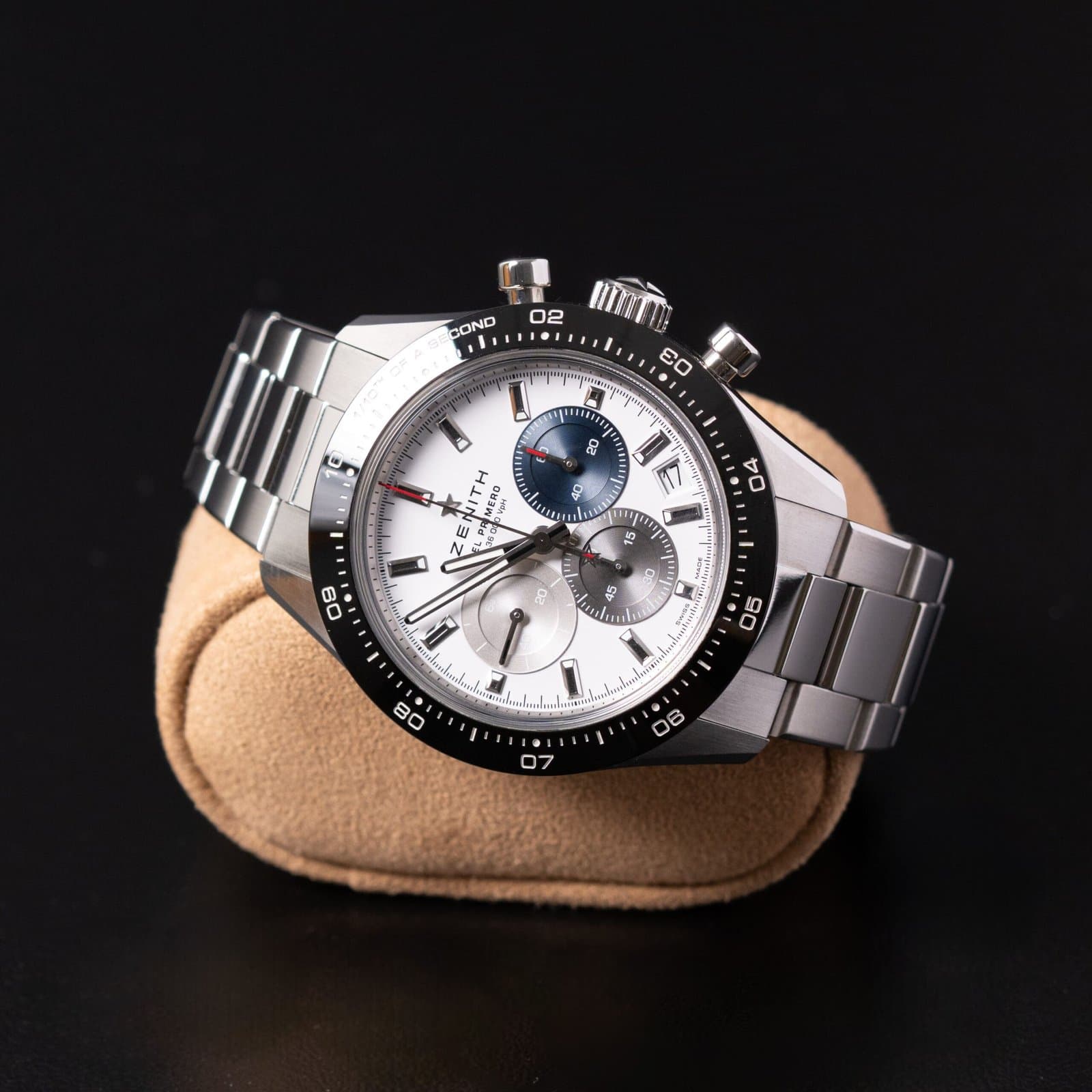 Pre-owned Zenith El Primero chronograph in steel with a white dial, resting on a suede watch pillow