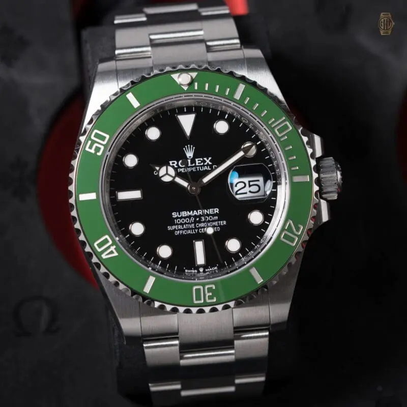 Rolex Submariner stainless steel watch with black dial and green ceramic bezel