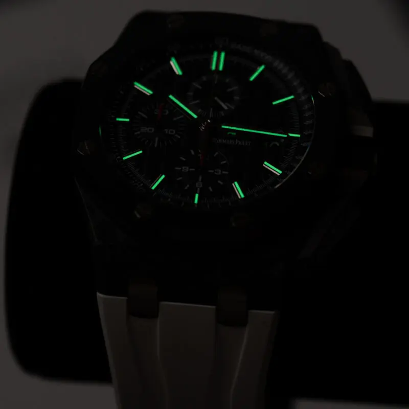 Audemars Piguet watch dial glowing in the dark with luminous hour markers and hands