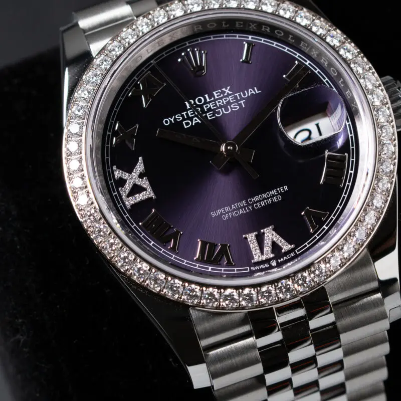 Rolex Datejust with purple sunburst dial, diamond bezel, and Roman numeral hour markers on Jubilee bracelet